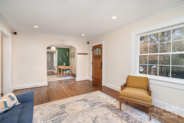 unfurnished room featuring hardwood / wood-style floors and crown molding