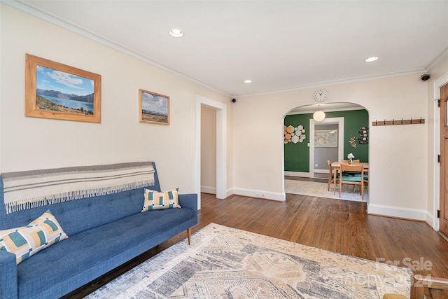 living room with crown molding and hardwood / wood-style floors