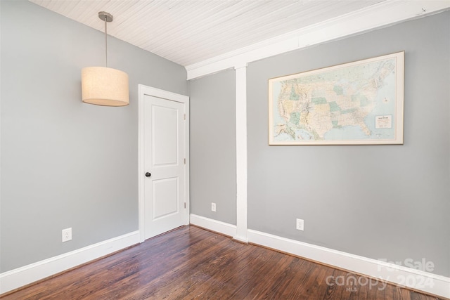 spare room featuring dark wood-type flooring