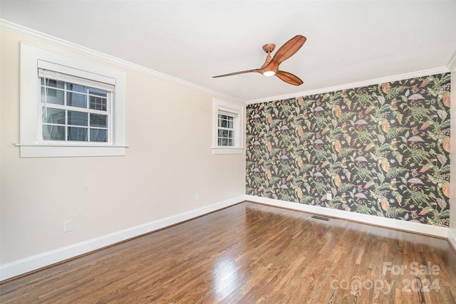 spare room featuring hardwood / wood-style flooring, ceiling fan, and crown molding