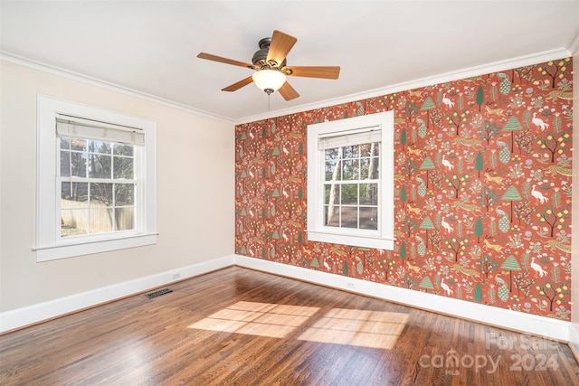 unfurnished room with hardwood / wood-style floors, ceiling fan, and crown molding