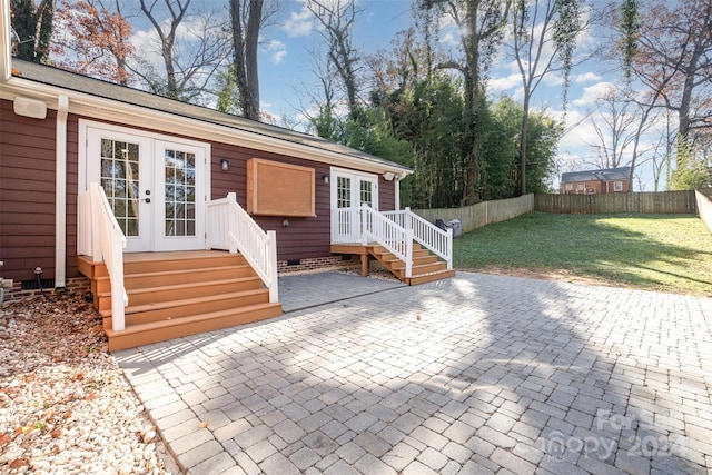 exterior space with french doors, a front lawn, and a patio area