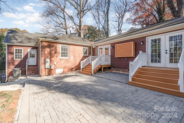 rear view of house featuring a patio area and french doors