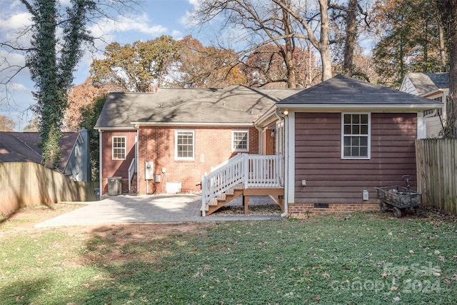 back of property featuring a patio area and a yard