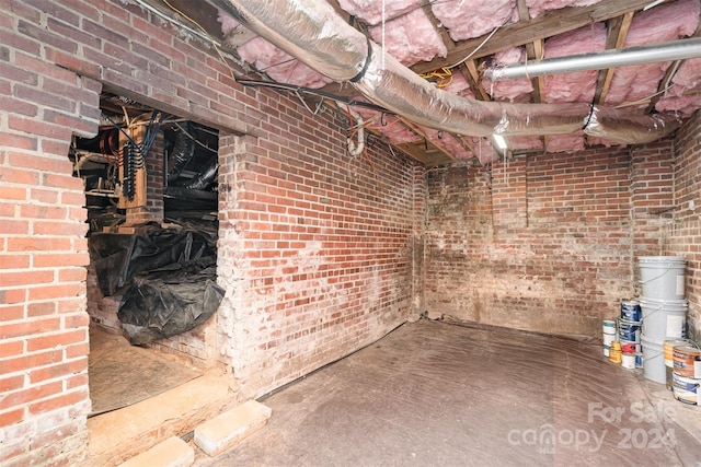 basement featuring brick wall