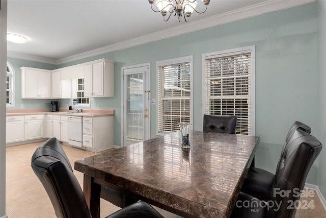 dining space with a notable chandelier, ornamental molding, and sink