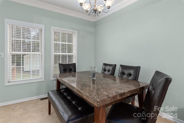 tiled dining room featuring ornamental molding, plenty of natural light, and a notable chandelier