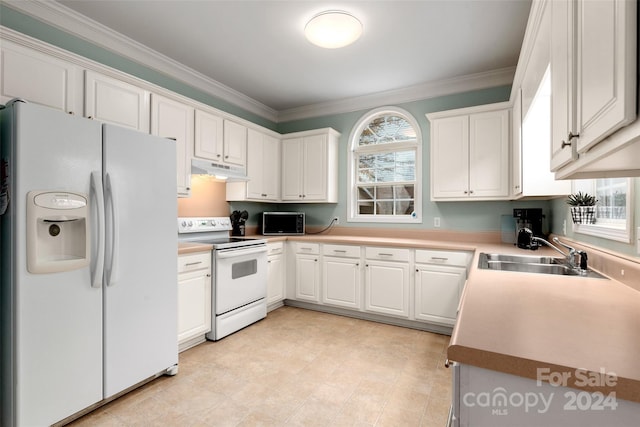 kitchen with white appliances, white cabinetry, and a healthy amount of sunlight