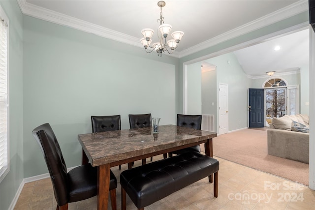 carpeted dining space with ornamental molding, an inviting chandelier, and lofted ceiling