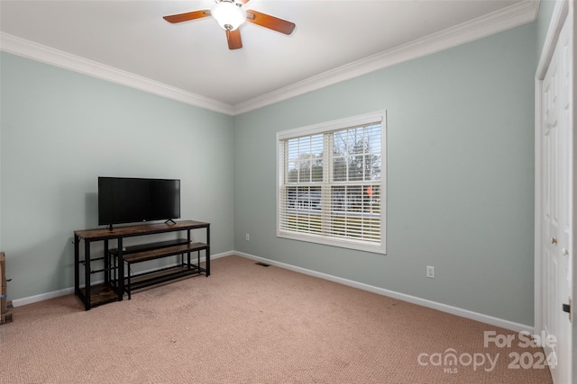 bedroom featuring light colored carpet, a closet, ornamental molding, and ceiling fan