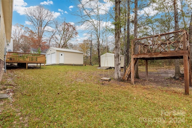 view of yard with a wooden deck and a storage shed