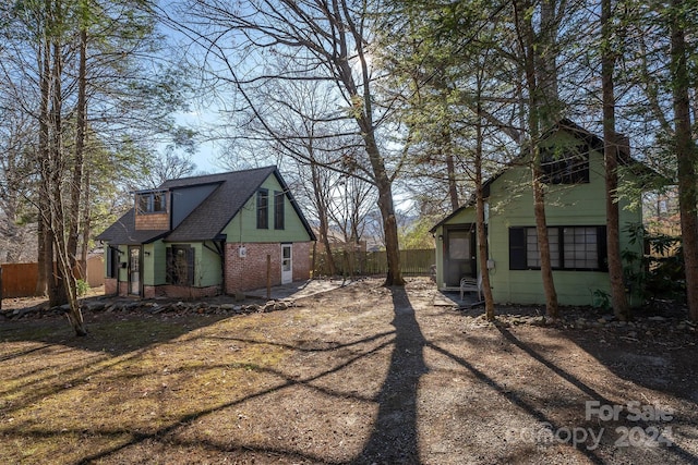 103 Pine St, Black Mountain, NC 28711 - back of property featuring roof with shingles and brick siding