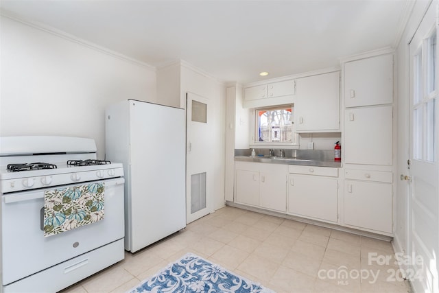 kitchen with stainless steel counters, white cabinets, white appliances, light tile patterned floors, and ornamental molding