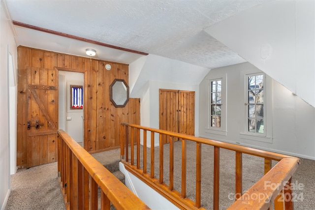 103 Pine St, Black Mountain, NC 28711 - corridor with carpet flooring, a textured ceiling, wood walls, and lofted ceiling