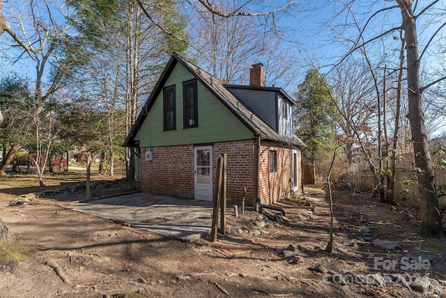103 Pine St, Black Mountain, NC 28711 - view of side of home featuring brick siding and a chimney