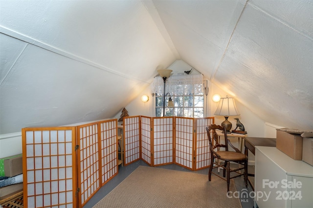 bonus room with carpet flooring, lofted ceiling, and a textured ceiling