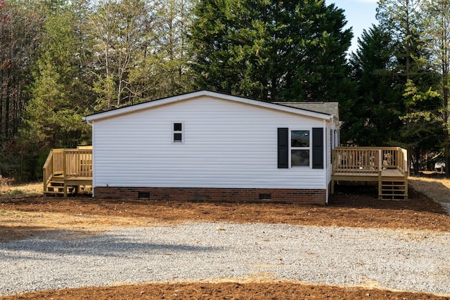 view of side of home featuring a wooden deck