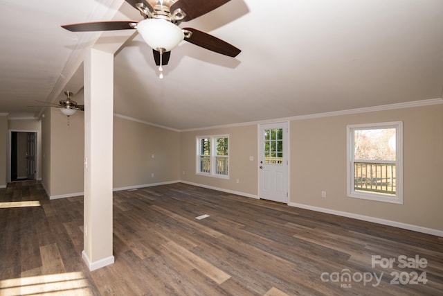 unfurnished living room featuring dark hardwood / wood-style floors, a wealth of natural light, and ornamental molding