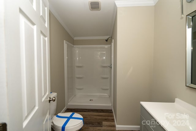 bathroom with a shower, toilet, wood-type flooring, and ornamental molding