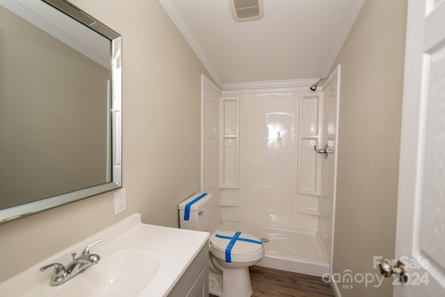 bathroom featuring hardwood / wood-style flooring, toilet, ornamental molding, and walk in shower