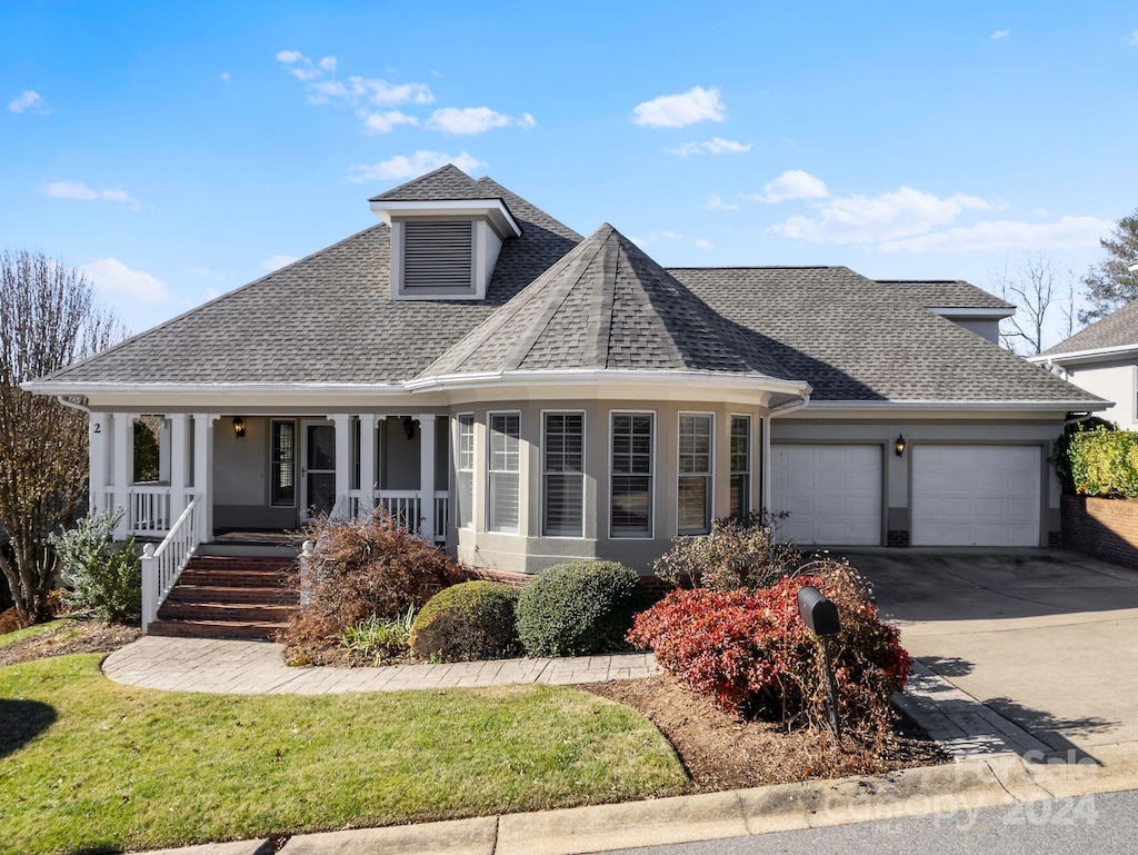 view of front of house with covered porch and a garage