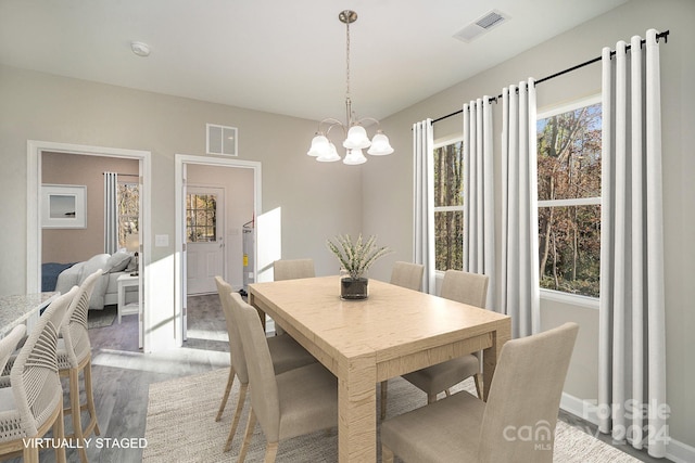 dining area with a chandelier and hardwood / wood-style flooring