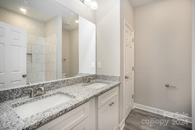 bathroom with toilet, vanity, and hardwood / wood-style flooring