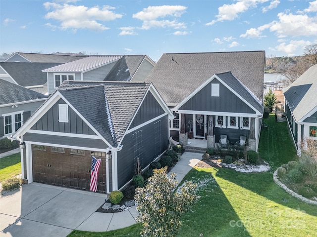 craftsman inspired home featuring a front lawn, a porch, board and batten siding, a shingled roof, and a garage