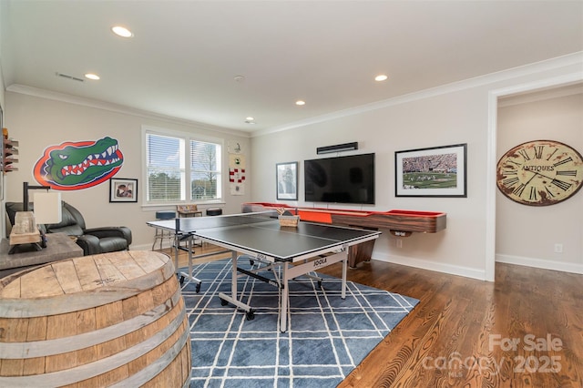 game room with dark wood-type flooring and ornamental molding