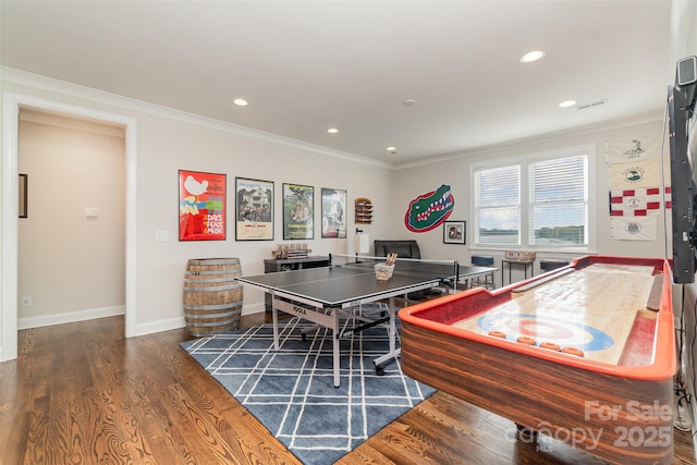 rec room with crown molding and dark hardwood / wood-style flooring