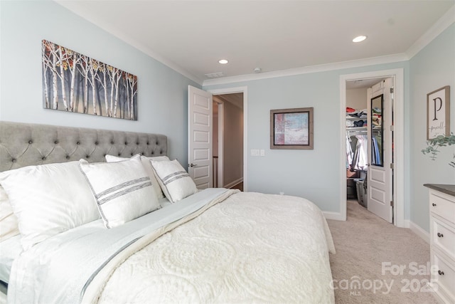 bedroom featuring crown molding, a walk in closet, light carpet, and a closet