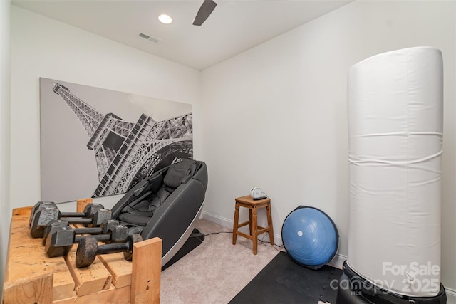 workout area with ceiling fan and light carpet