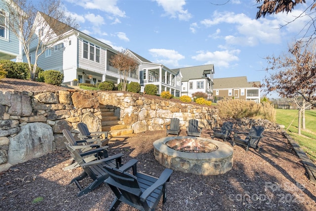 view of yard featuring a sunroom and a fire pit