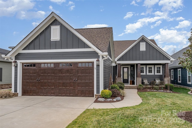 craftsman-style house featuring board and batten siding, concrete driveway, a front yard, roof with shingles, and an attached garage