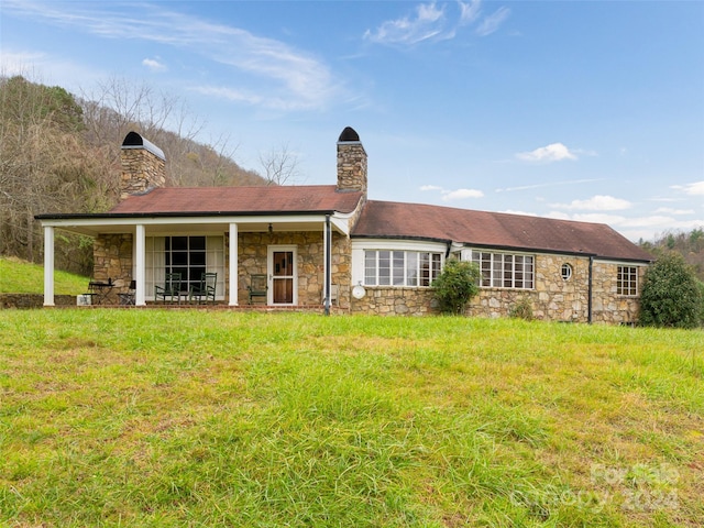 back of house with a lawn