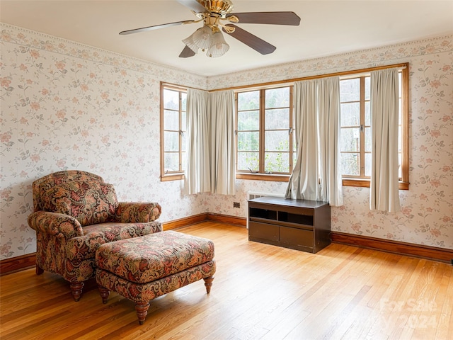 sitting room with ceiling fan and light hardwood / wood-style flooring