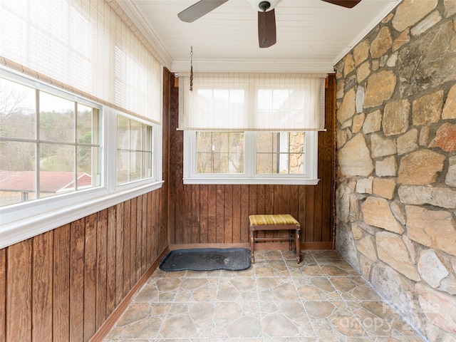 unfurnished sunroom with a wealth of natural light and ceiling fan