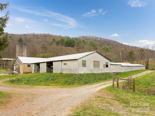 view of home's exterior with an outbuilding