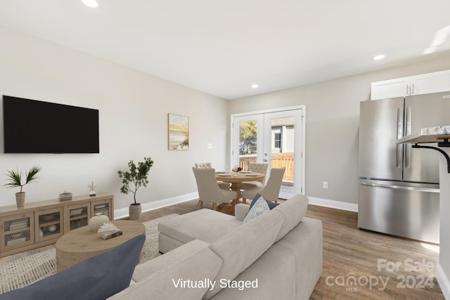 living room with wood-type flooring and french doors