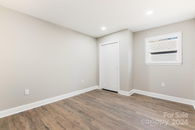 unfurnished bedroom featuring hardwood / wood-style floors and a closet