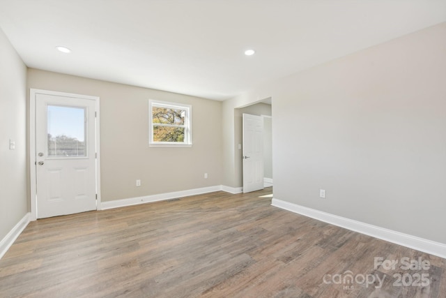 unfurnished room with recessed lighting, baseboards, and wood finished floors