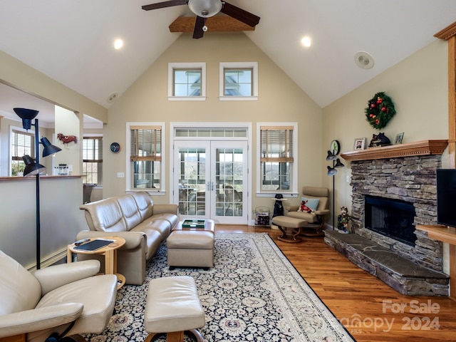 living room with high vaulted ceiling, a healthy amount of sunlight, and wood-type flooring