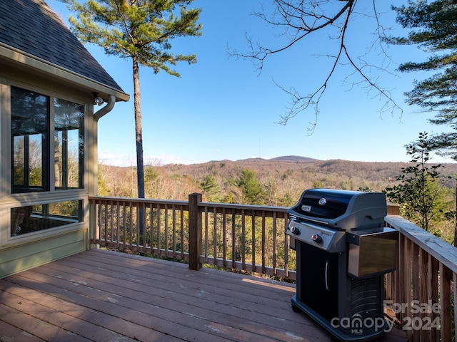 wooden deck featuring grilling area and a mountain view