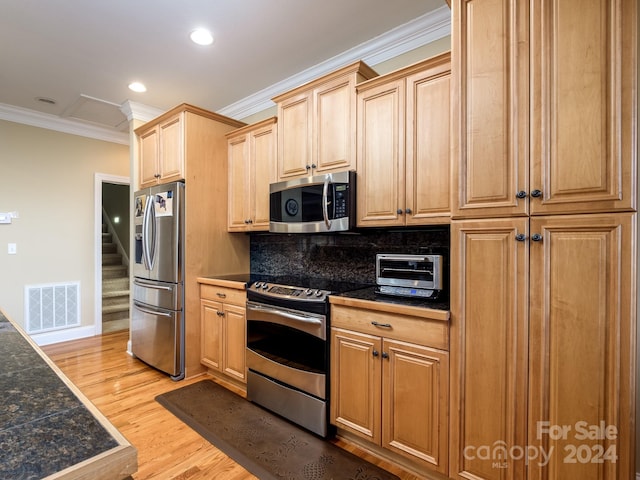 kitchen featuring light hardwood / wood-style floors, ornamental molding, appliances with stainless steel finishes, and tasteful backsplash