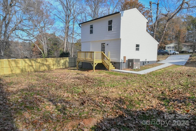 back of property featuring a wooden deck and central AC unit