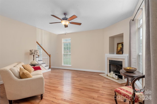 living room with ceiling fan and light wood-type flooring