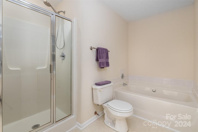 bathroom featuring shower with separate bathtub, tile patterned flooring, a textured ceiling, and toilet