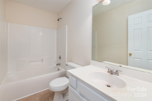 full bathroom featuring tile patterned floors, bathing tub / shower combination, a textured ceiling, toilet, and vanity