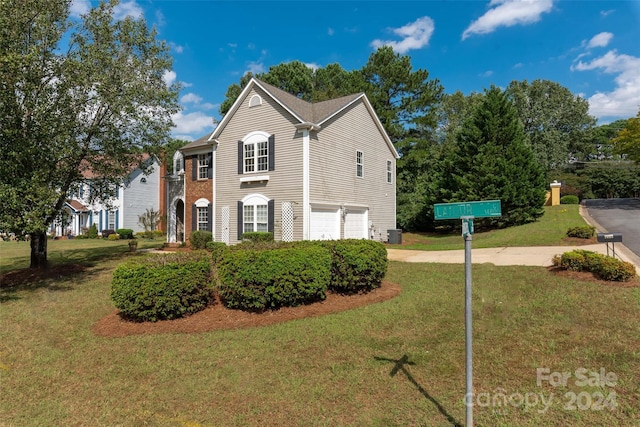 view of property exterior featuring a garage and a lawn