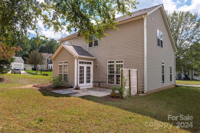 rear view of house with french doors, a yard, and a patio area